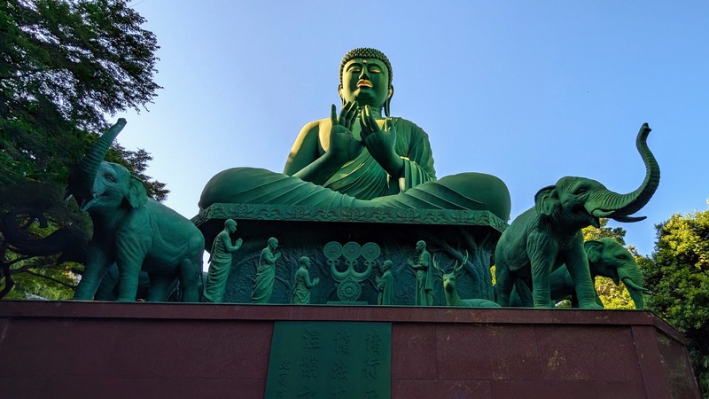 The giant Buddha sculpture surrounded by elephant and people sculptures