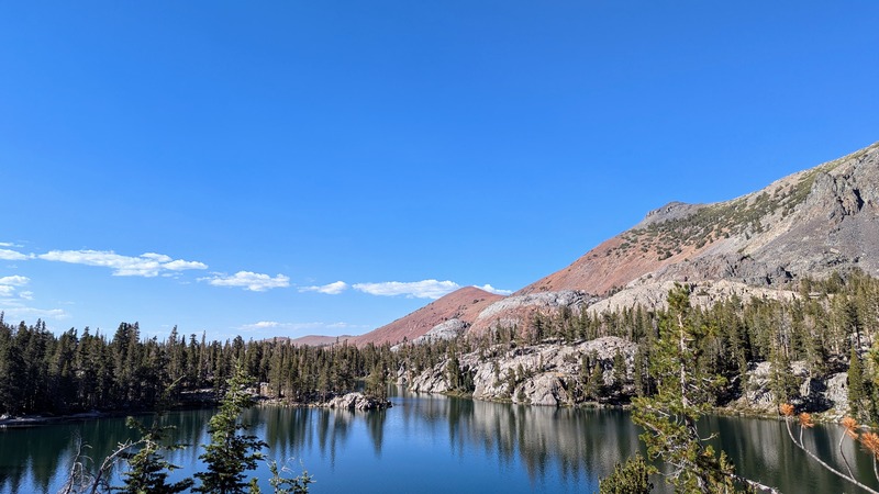 Mountains and evergreen trees reflecting in a lake