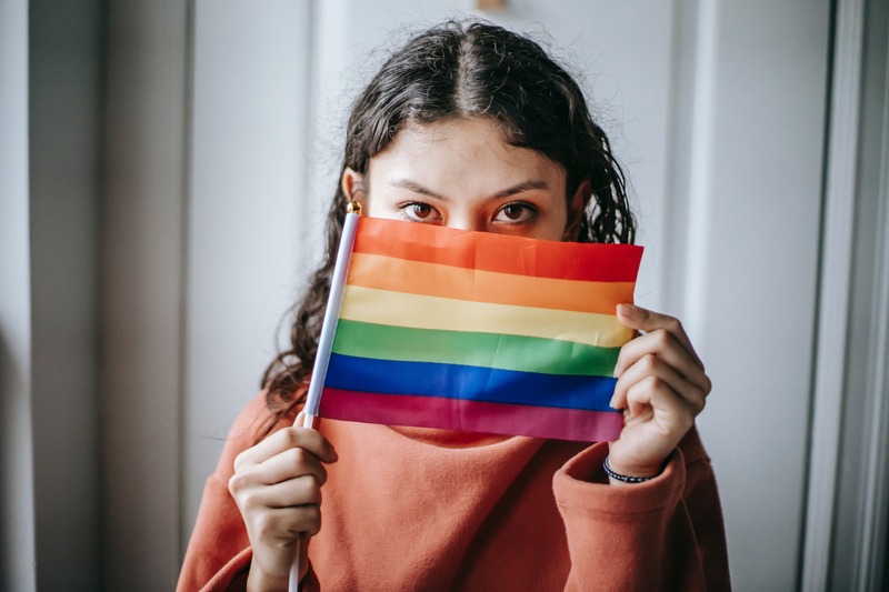 Person holding rainbow flag