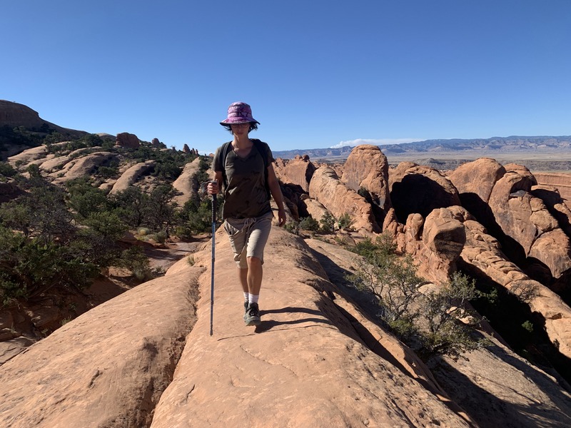 Rey walking on the crest of a very large sandstone rock