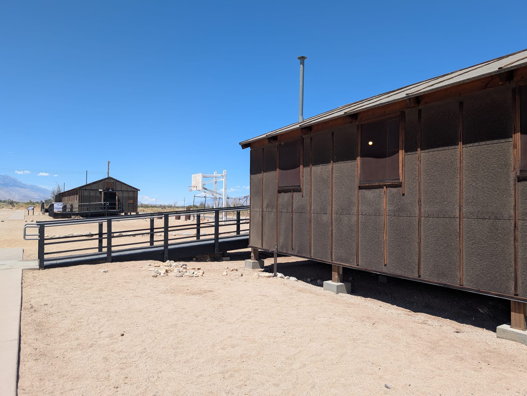A barracks on sand where Japanese-Americans lived