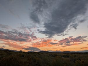 A blue and pink sunset sky with clouds in the Eastern Sierras
