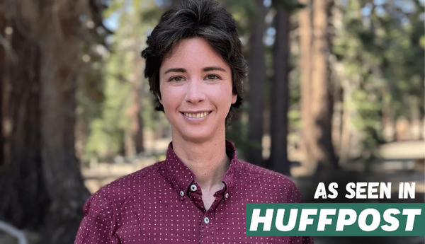 A photo of Rey, a white non-binary person with short hair, smiling, with the content: as seen in HuffPost